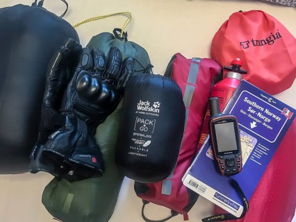 Bakum, Melle, Lower Saxony, Germany, camping equipment on a table with tent, stove, gloves and GPS