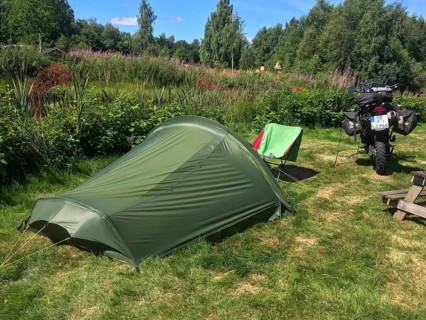 Växjö, Kronobergs län, Sweden, green campground with camping chair and BMW G 650 GS Sertao enduro