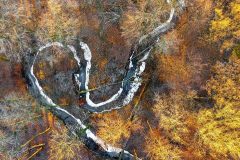 Frozen Määnder river loop of a stream in the Osnbrücker Land seen from the air, Melle, Lower