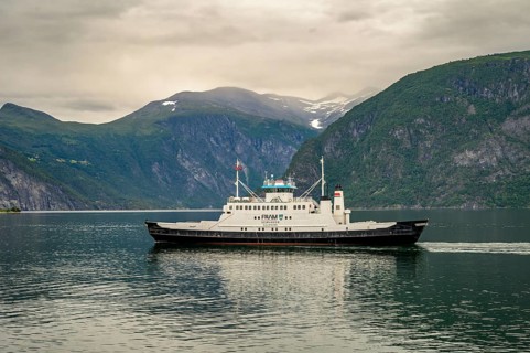 Valldal, Møre og Romsdal province, Norway, Fram Geiranger ferry in calm water surrounded by high