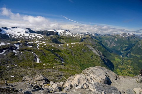 Geiranger, Møre og Romsdal province, Norway, view over snow-capped mountains and a green valley