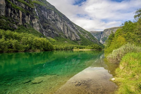 Åndalsnes, Møre og Romsdal province, Norway, Clear river surrounded by green landscape flanked by