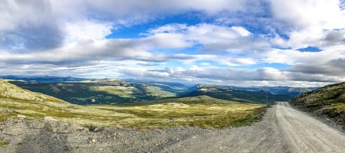 Tylldal, Innlandet, Norway, panoramic view of mountains and a dirt road under cloudy sky, Norway's