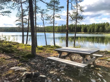 Storsjö Kapell, Jämtlands län, Sweden, A Scandinavian picnic table with fixed benches on the shore