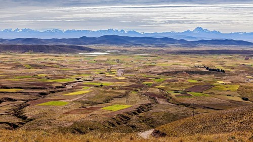 Wide landscape with fields and distant mountains, The Altiplano landscape in the Andes of Bolivia