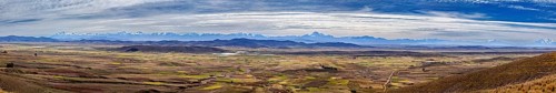 Extensive panorama with mountains and fields under cloudy sky, The Altiplano landscape in the Andes