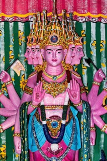 Colourful depiction of a multi-headed deity with detailed decorations, the Seema Malaka temple with