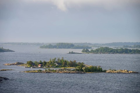 Small islands in the sea under a cloudy sky, calm and peaceful atmosphere, Aland Archipelago,