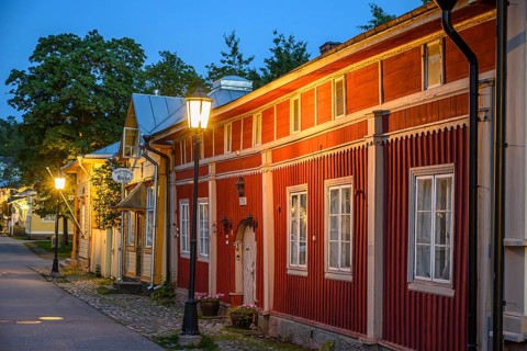 Street scene in the old town of Naantali, red historic wooden building with decorative windows on a