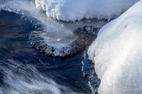 Ilsenburg, Saxony-Anhalt, Germany, detailed view of ice and snow on a flowing body of water on the