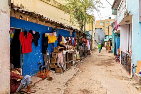 Alley with colorful walls and hung clothes in an urban setting, people in the streets of Slave