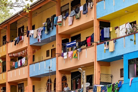 Apartment building with colorful facades and laundry hanging on the balconies, apartment building