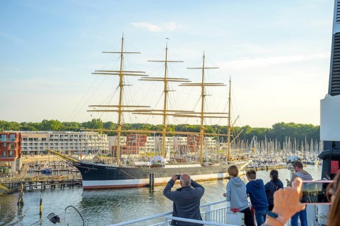 A large sailing ship the legendary 4 Mastbark Passat a flying P-liner with people taking photos