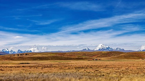 Wide hilly landscape with mountains and a cloudy sky, The Altiplano landscape in the Andes of
