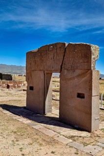 Ancient stone gate in open landscape with mountains and clear sky, The archaeological site with the