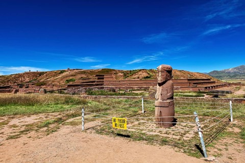 Stone statue in a ruined landscape with a prohibition sign in the foreground, The archaeological