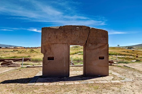 Monumental stone gate on a wide area with blue sky in the background, The archaeological site with