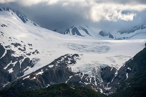 Mountain peak with Worthington Glacier glacier, dramatic cloudy sky, picturesque landscape on