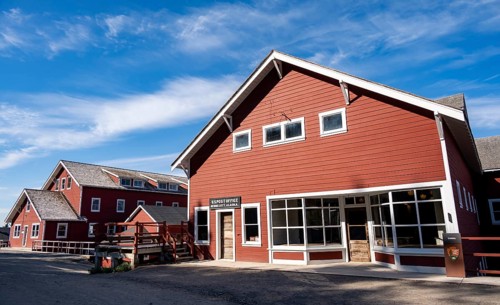 Red Kennicott buildings against mountainous landscape, Kennecott Post Office, Historic Kennecott