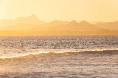Evening light at Cape Byron with view to Mount Warning and sunlit hinterland, New South Wales,