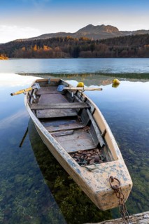 Wooden rowing boat on wintry Reintaler See, Reintaler See, Tyrol, Austria
