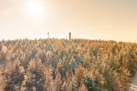A bright winter sun over a snowy landscape with tower, Holohturm, Gernsbach, Rastatt district,