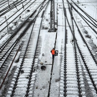 Railway workers between many tracks in winter, train formation in the Vorhalle district,