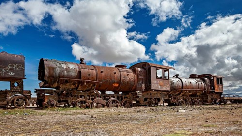 Abandoned, rusted locomotive in a dramatic cloudy landscape, old rusty locomotives at the train