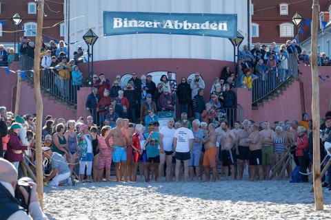 Tourists waiting in front of the spa hotel to bathe, swimmers ready to start in the water, tourist