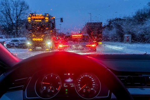 Driving in winter, in snow, rain, rear lights, brake lights, speedometer, cockpit