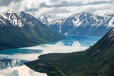View of snowy mountains in spring and turquoise Kenai Lake with reflection, Slaughter Ridge Trail,