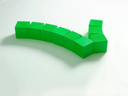 9 green wooden cubes against a white background