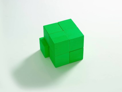 8 green wooden cubes against a white background