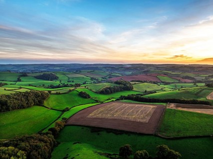 Sunset of Devon Farms and Fields over Berry Pomeroy from a drone, Totnes, England, United Kingdom