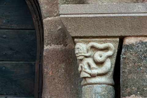 Sculptural details on the porch of the Romanesque church in Azerat village, Haute Loire,