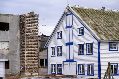 A traditional building with blue and white accents and a striking façade is seen next to an