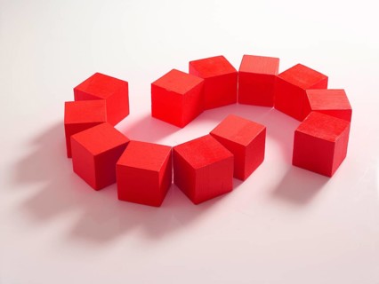 12 red wooden cubes against a white background