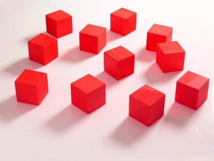 11 red wooden cubes against a white background