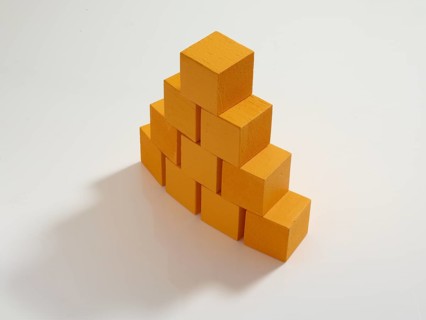 10 yellow wooden cubes against a white background