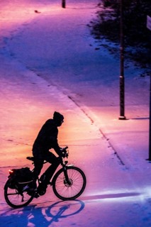 Winter weather, blowing snow, person with e-bike, bicycle on snowy road, North Rhine-Westphalia,
