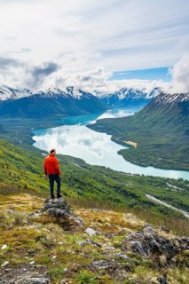 Climber enjoying the view, Slaughter Ridge Trail, view of snowy mountains and turquoise blue Kenai