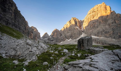 Picturesque mountain landscape in Val Brenta Alta at sunrise, rocky peaks of Cima Tosa,
