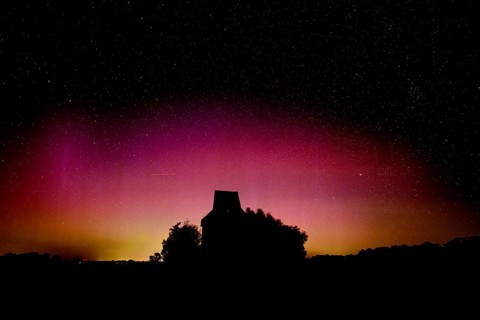 Colourful polar lights over the EXPO observatory in front of a starry night, EXPO Observatory,