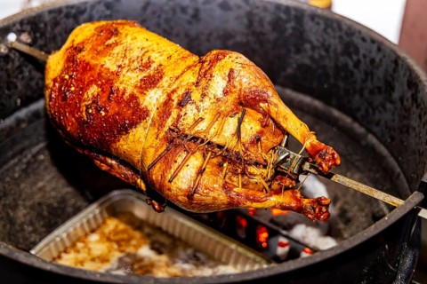 Christmas goose is grilled on a kettle grill. Münsingen, Baden-Württemberg, Germany