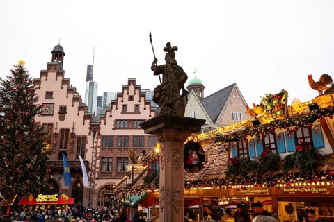 December 22, 2025, Frankfurt Christmas Market on Roemerberg at twilight. Traditional wooden stalls