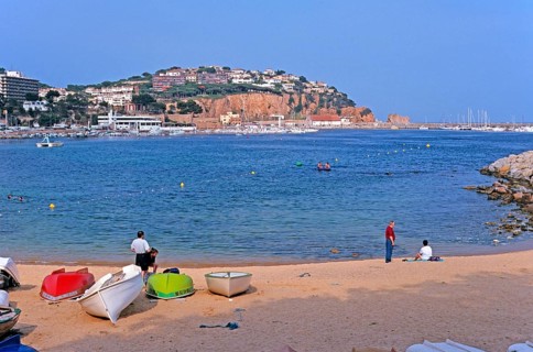 People, boats, Sant Feliu de Guixols beach on the Costa Brava, Spain, June 1999, vintage, retro,