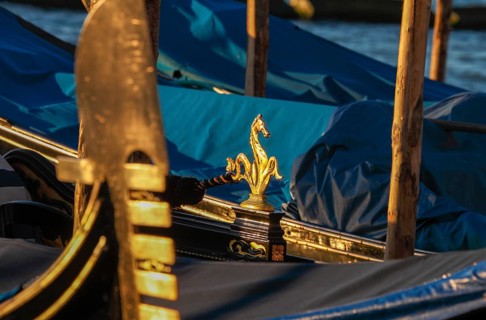 Arch iron, ferro and gondola decoration of a gondola at sunrise, Venice, Veneto, Italy