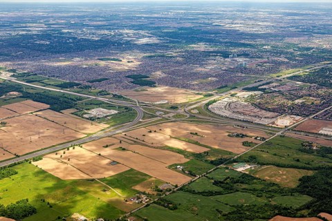 The border between urban and agricultural areas is clearly visible from the air, as seen from an