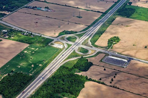 A large road junction surrounded by fields and green spaces, visible from the air, view from an
