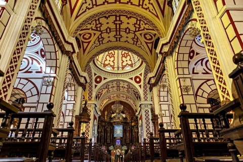 Sumptuous church interior with ornate ceilings and red patterns, The Basilica of St. Francis in